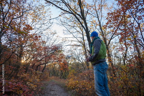 Man controls the drone in the autumn forest