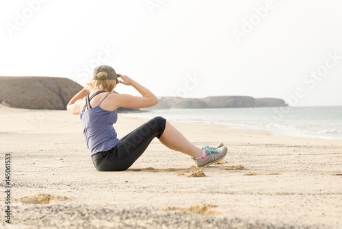 Woman Doing Torso Stretches by the Seaside