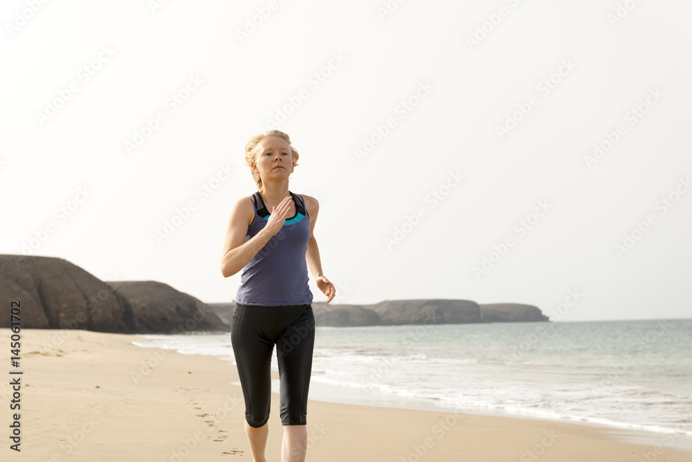 Fit Woman in Sportswear Running in the Beach Fit Woman in Sportswear Running in the Beach