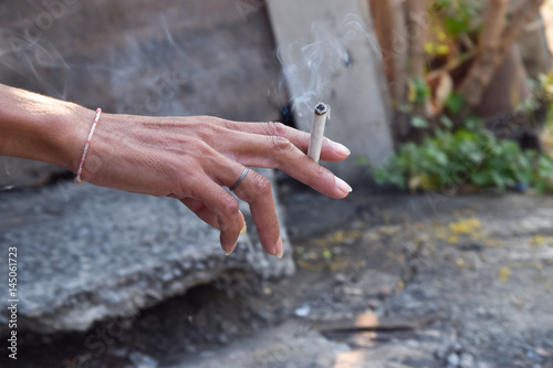 Cigarette in man hand. © teerawat