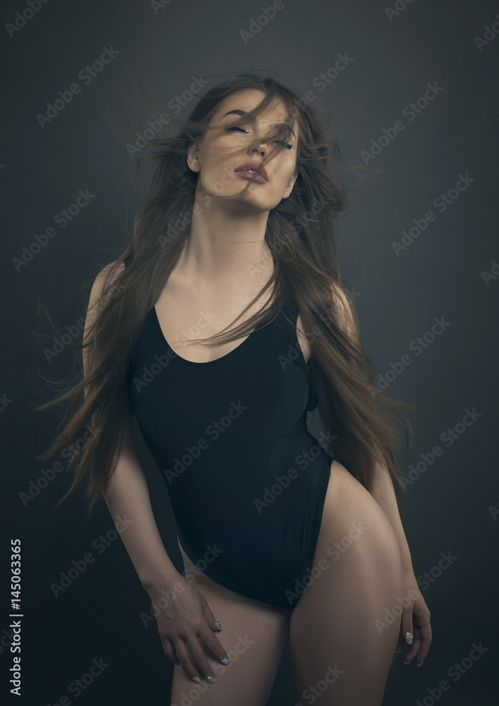 woman fashion shot in black lingerie wind hair