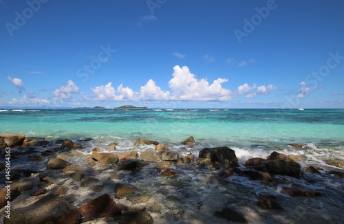 Beach Grand Anse, Praslin Island, Seychelles, Indian Ocean, Africa / The beautiful white sandy beach is bordered by large red granite rocks.