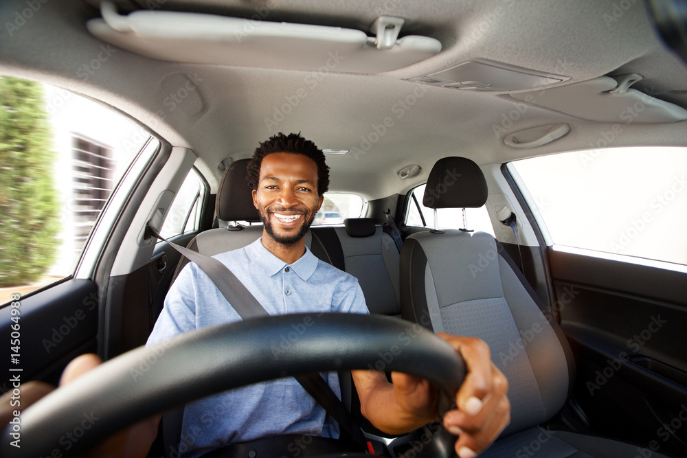 happy african american man with beard driving car happy african american man with beard driving car