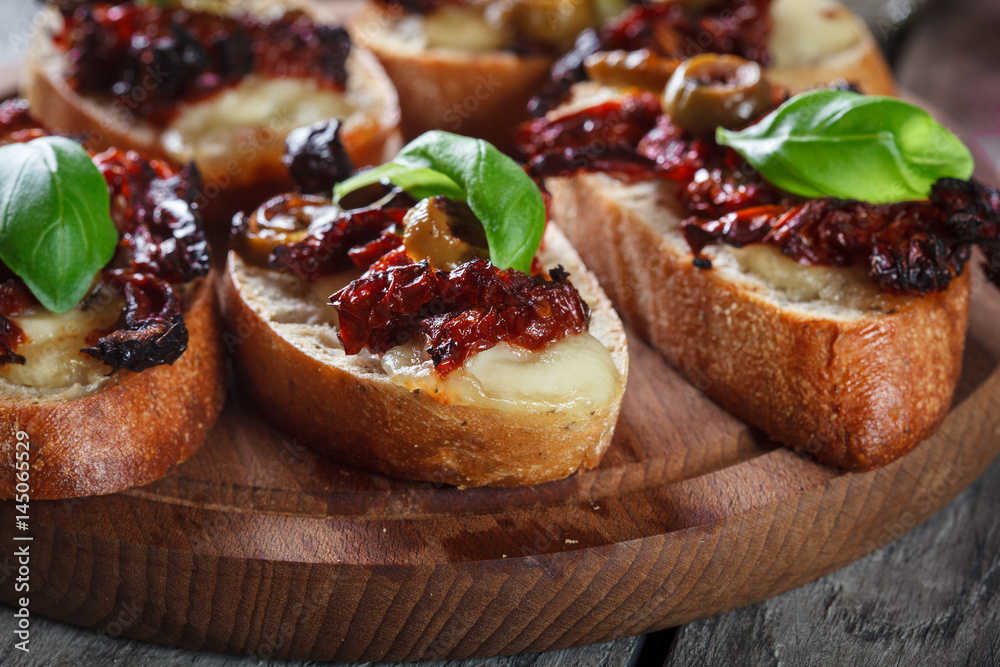 Appetizer bruschetta with sun-dried tomatoes, olives and mozarella. Appetizer bruschetta with sun-dried tomatoes, olives and mozarella.