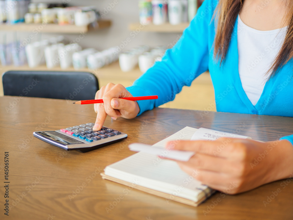 woman working with calculator, business document and laptop computer notebook woman working with calculator, business document and laptop computer notebook