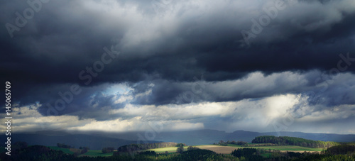 dark rainy clouds and shafts of sunlight