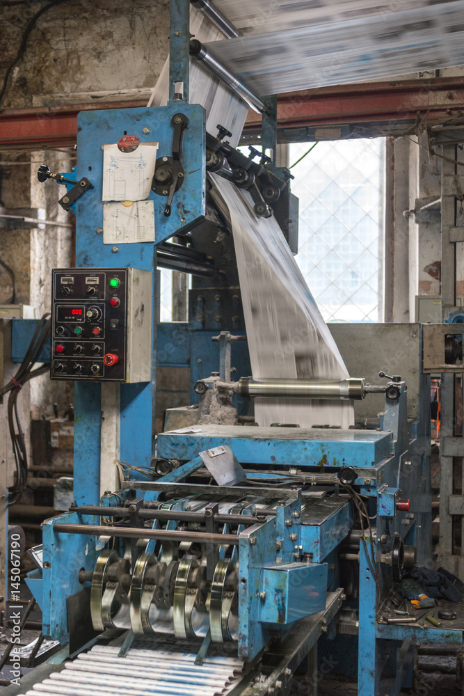 Printing press with blurred paper in work. Printing press with blurred paper in work.
