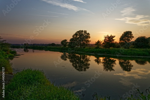 A beautiful sunset over the river. © sangri