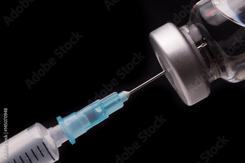 Medical syringe with the needle in the vial