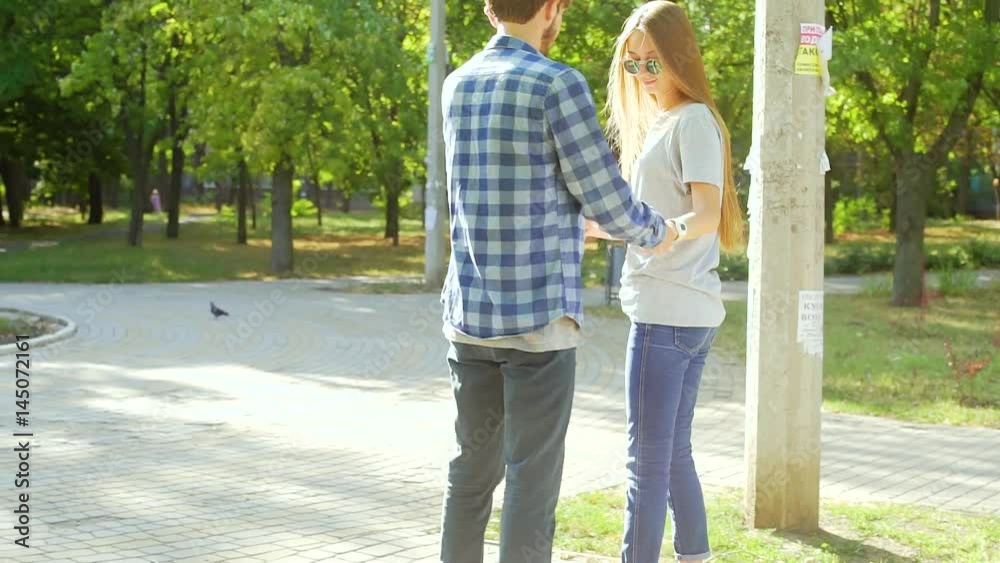 Young couple having fun with scooter