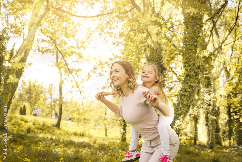 Fototapeta premium Mother and daughter outdoors in a meadow.