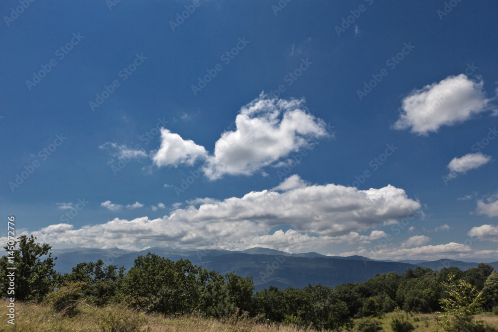 Summer mountains green grass and blue sky with clouds landscape.