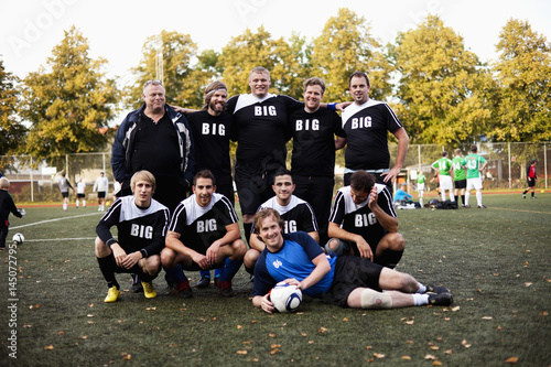 Portrait of happy soccer team at field photo