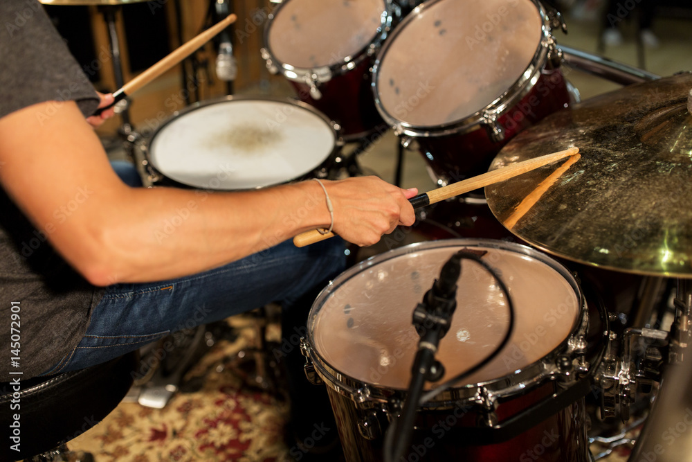 male musician playing drums and cymbals at concert male musician playing drums and cymbals at concert
