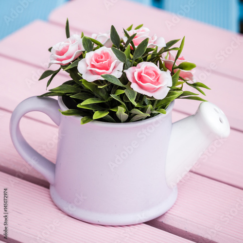 Artificial Flowers in White Flowerpots on Pink Wooden Background