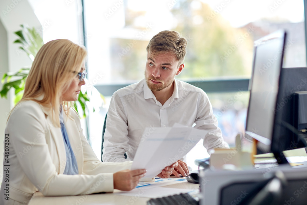 business team discussing papers at office table business team discussing papers at office table