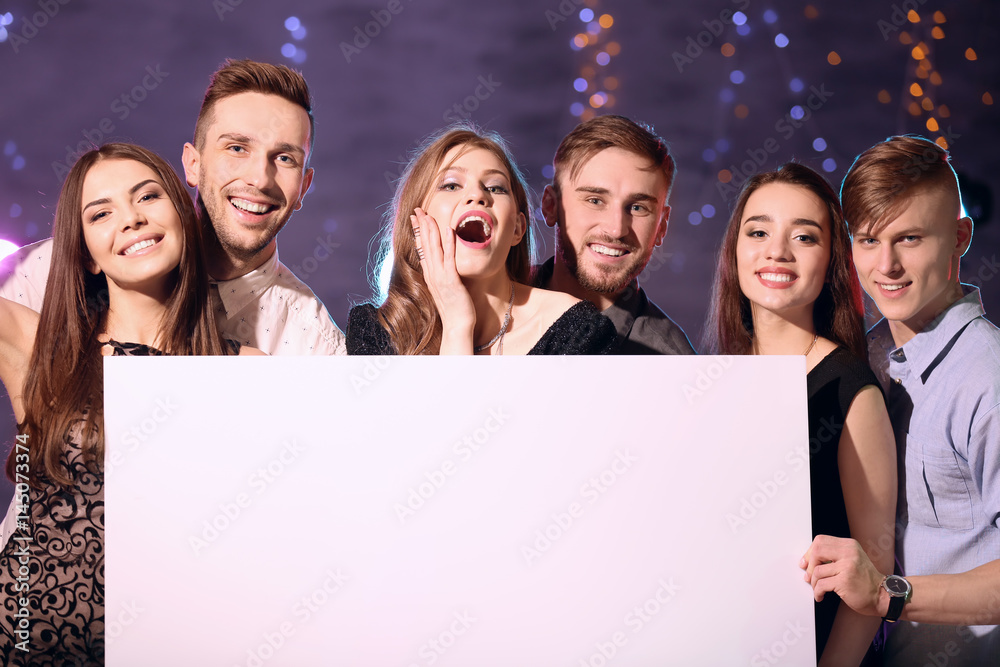 Friends with poster at party in night club Friends with poster at party in night club