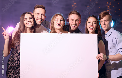 Friends with poster at part...