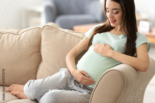 Beautiful pregnant woman si...