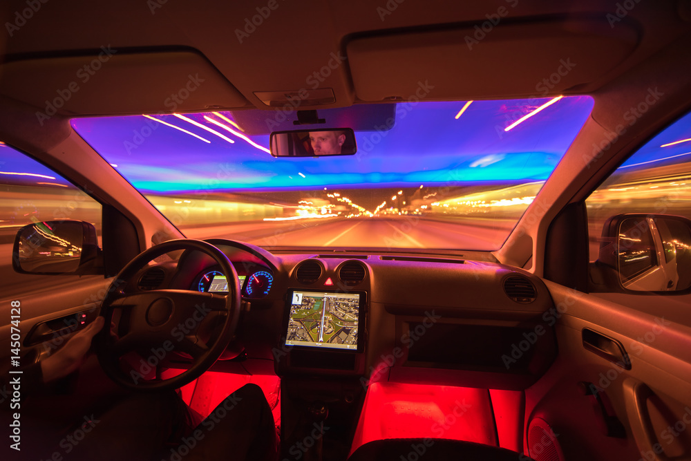 The man drive on the night highway. Inside view. Wide angle The man drive on the night highway. Inside view. Wide angle
