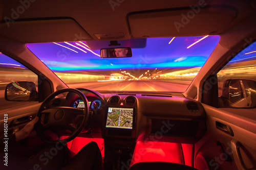 The man drive on the night highway. Inside view. Wide angle