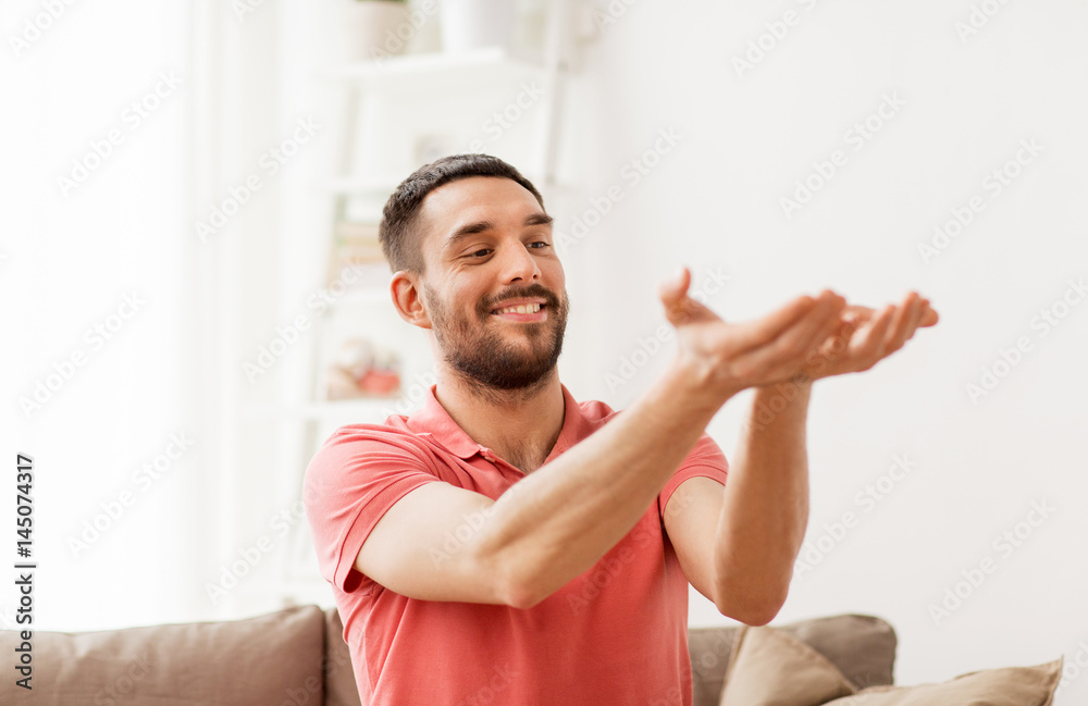 happy man holding something imaginary at home happy man holding something imaginary at home