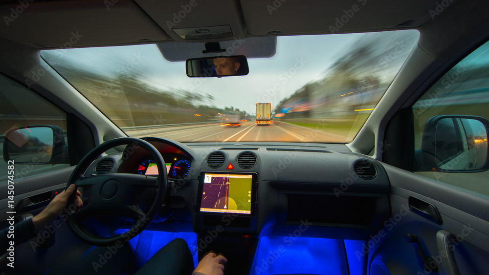 The man drive a vehicle on the highway. Inside view. Wide angle The man drive a vehicle on the highway. Inside view. Wide angle