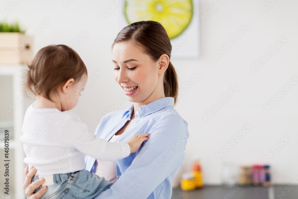 Fototapeta premium happy mother and little baby girl at home kitchen