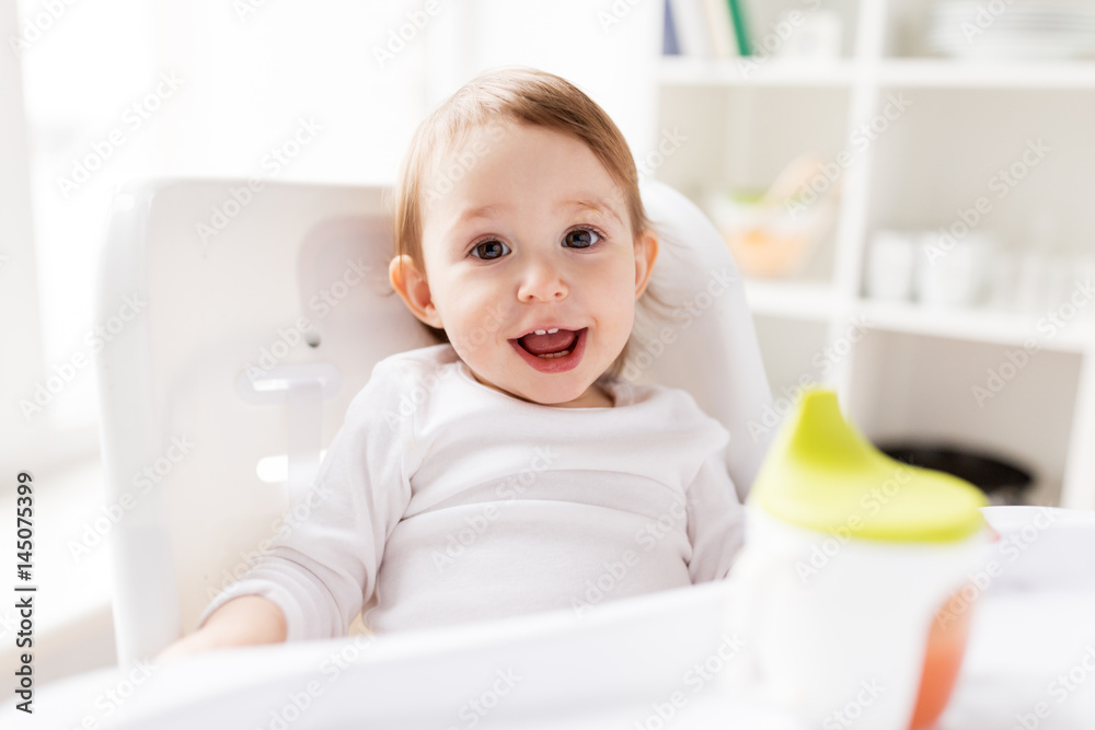 happy smiling baby sitting in highchair at home happy smiling baby sitting in highchair at home