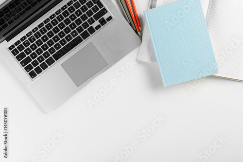 Laptop, notebooks and pencils on white background