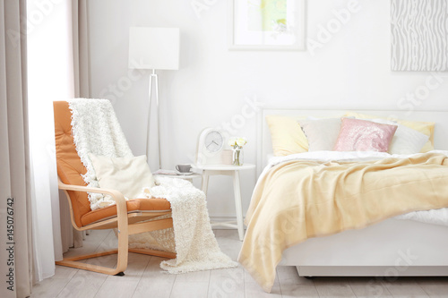 Chair near comfortable bed ...
