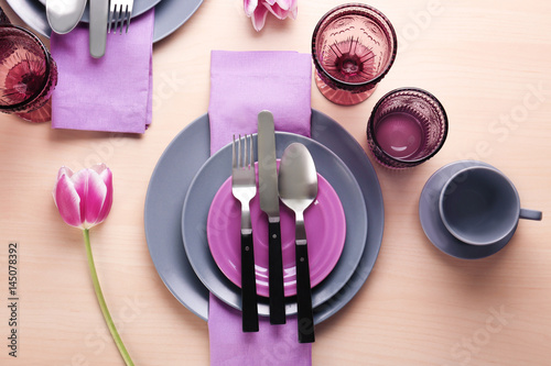 Beautiful table setting on light wooden background