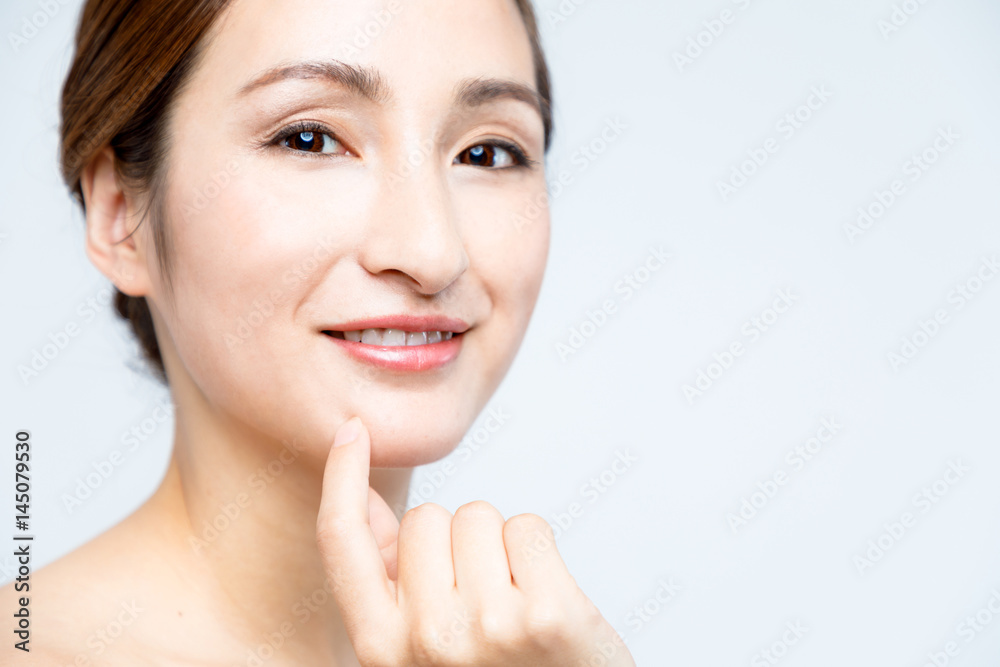 middle aged woman who checks her skin. acne treatment.