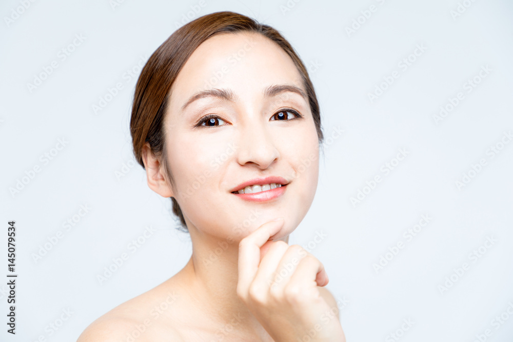 middle aged woman who checks her skin. acne treatment.