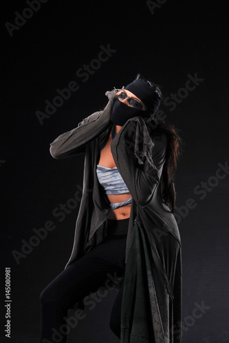     Warrior woman in different design clothes on black background 