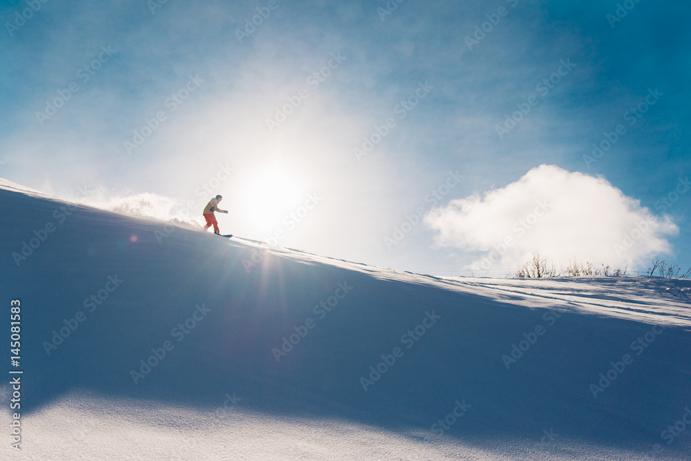 snowboarder is riding from snow hill