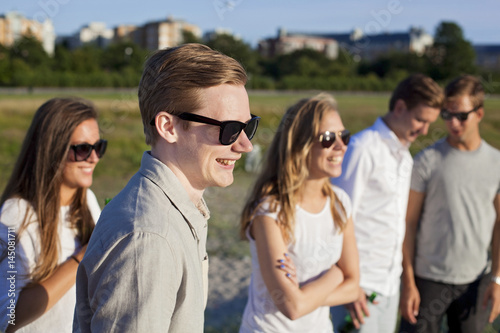 Smiling young friends on field at beach photo