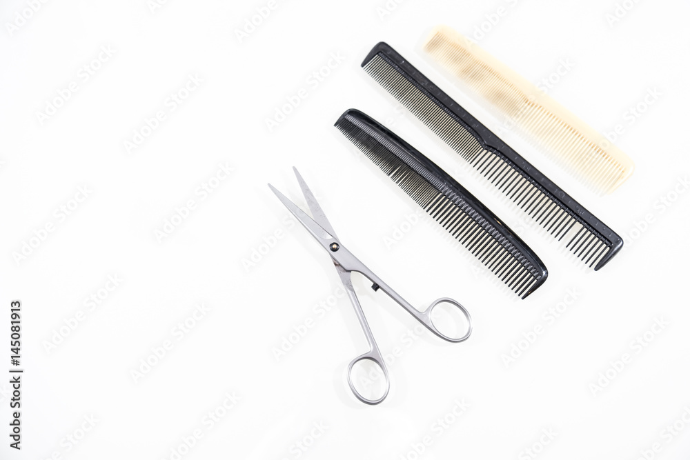 Hair cutting shears and comb isolated on white Hair cutting shears and comb isolated on white