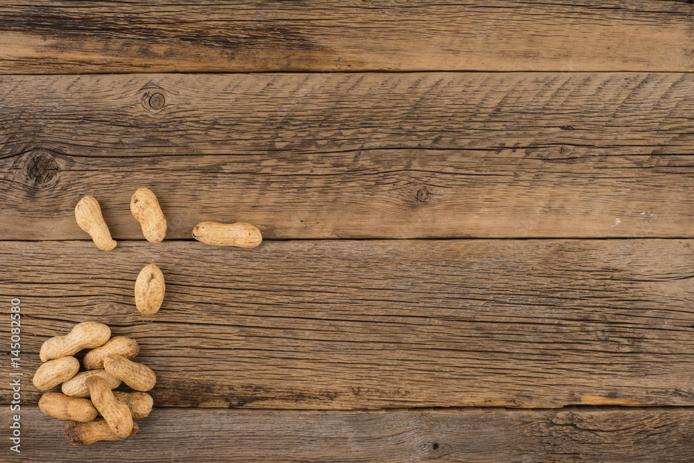 Peanuts on the background of the old wooden table.