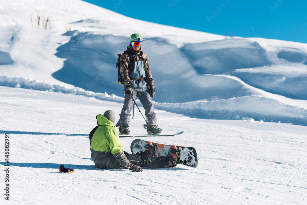 snowboarder trainer teach man sitting with snowboard