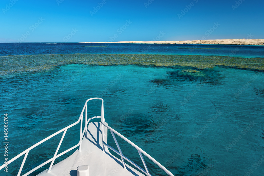 View at the coral sea from white yacht. Perfect place for snorkeling. Summer vacation in Egypt. Red sea with clear turquoise water.