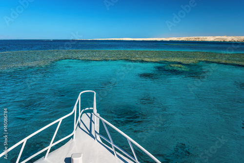 View at the coral sea from white yacht. Perfect place for snorkeling. Summer vacation in Egypt. Red sea with clear turquoise water.