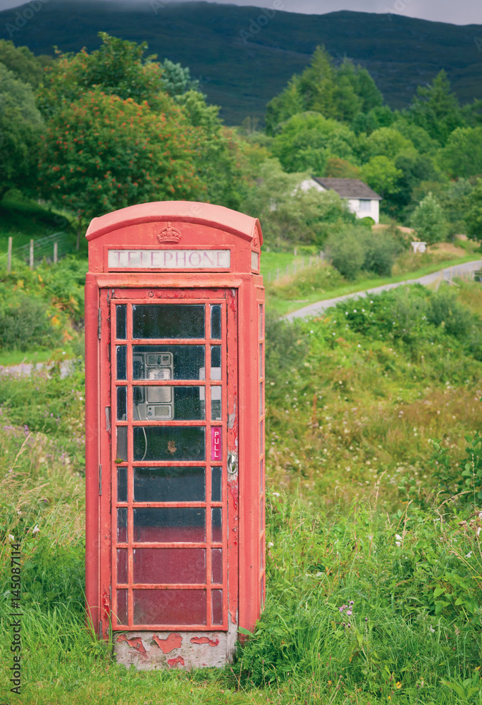 Old weathered red telephone kiosk in Scotland Old weathered red telephone kiosk in Scotland