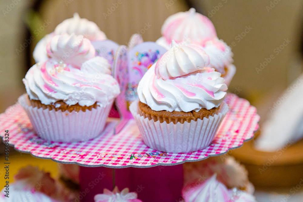 nice girlish pink and white cupcakes on the plate
