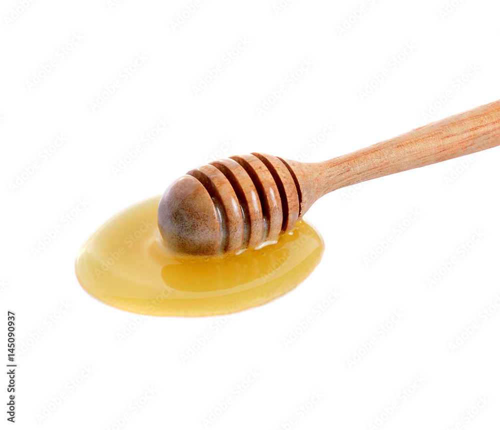 Honey on wooden dipper isolated on white background Honey on wooden dipper isolated on white background