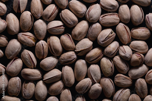 Full frame of roasted pistachios. Macro food photography. Top view.
