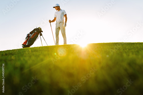 Male golfer standing on golf course