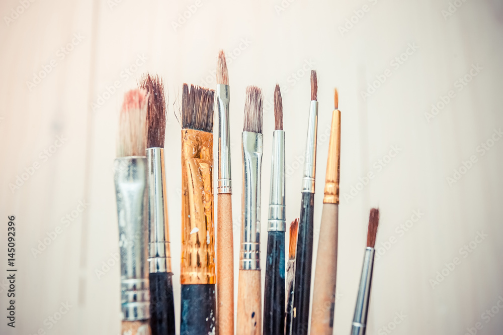 Obraz premium artistic brushes on wooden background 