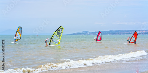 Mui Ne, Vietnam - February 19th, 2017: Guests are practice games windsurfing sail on the bay on a beautiful summer afternoon in Mui Ne, Vietnam