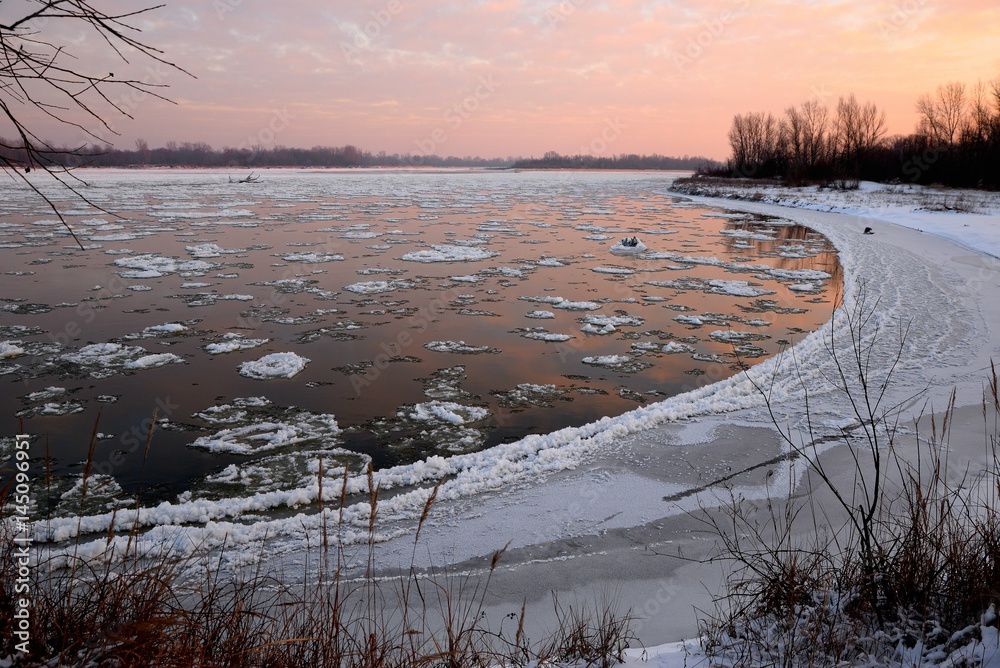 floe on the river and the sunset on a winter day